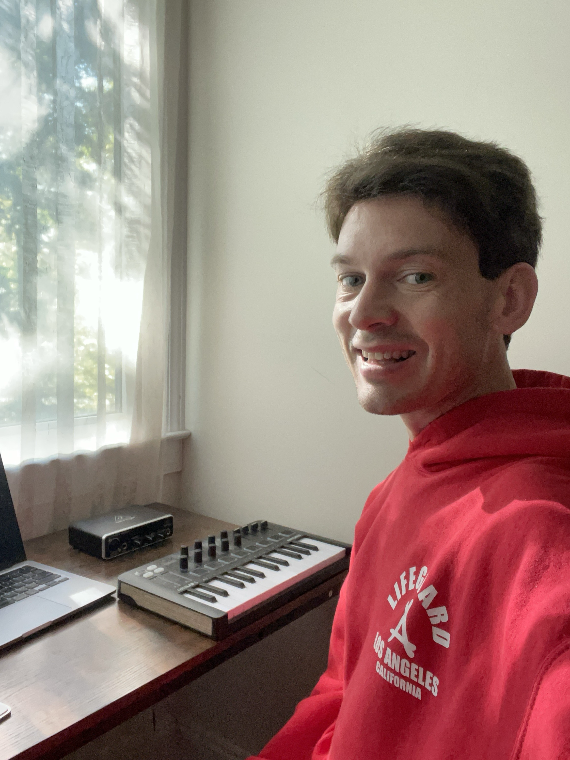 Profile photo of a music tech QA specialist working with a laptop and MIDI controller